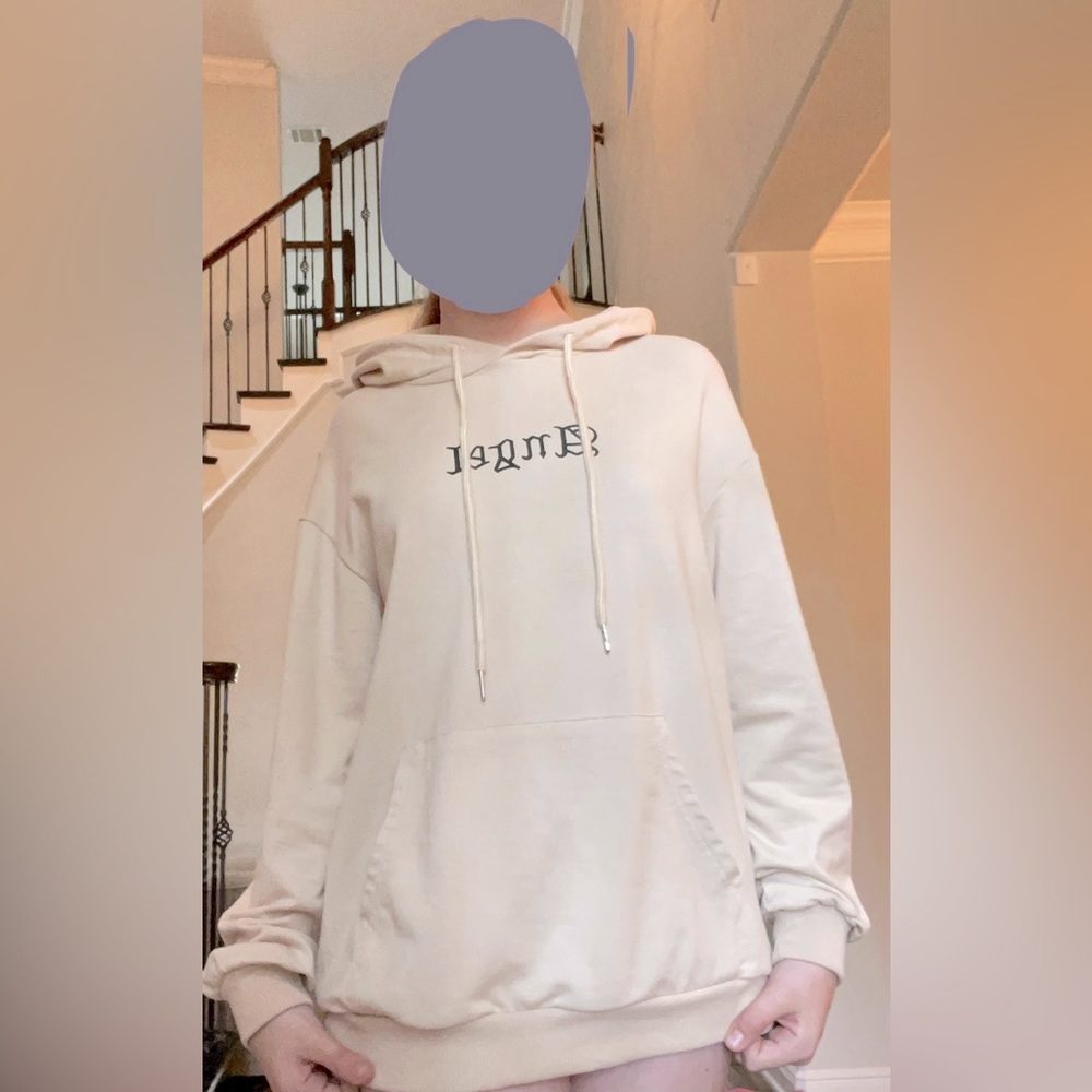 I am selling a tan sweatshirt that says angel on the front chest